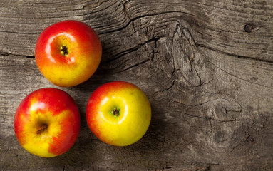ripe red apples on an old wooden gray background