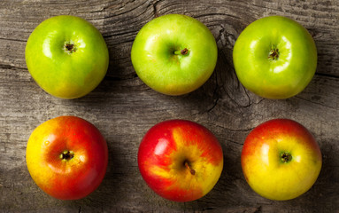 ripe red and green apples on an old wooden background