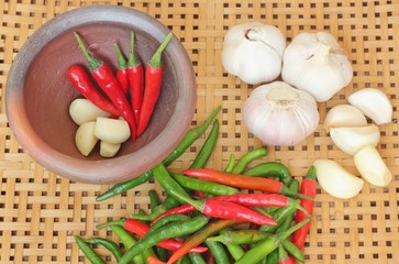 chili and garlic in mortar on wooden textured