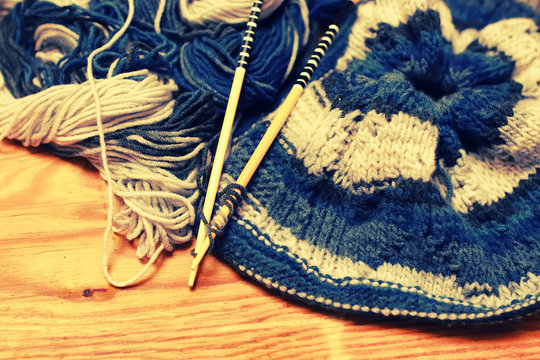 toned wool and knitting needles