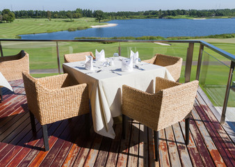 Table on terrace for eat foods at clubhouse in golf course.
