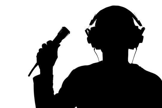 Silhouette of a young man listening to music with headphones