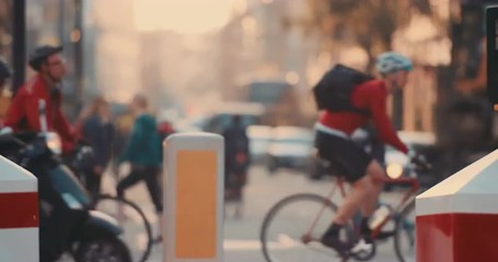 Anonymous crowd of people walking cycling bicycles commuters London City street slow motion - Powered by Adobe