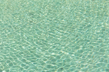 Fototapeta na wymiar Green swimming pool rippled water detail