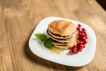 Pancakes with berries and maple syrup