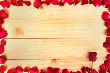 Frame shape made out of rose petals on wood background, Valentin
