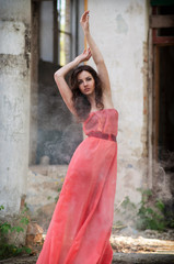 Sexy young beauty woman red dress in smoke