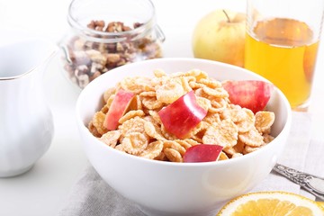 corn and rice flakes with Apple and a glass of Apple juice, a li