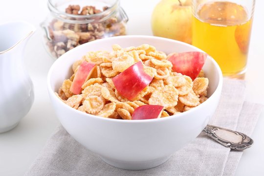 muesli with Apple pieces and Apple juice in a glass on white bac