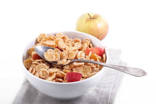 muesli with pieces of fresh Apple in a Cup on white background