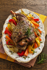 Roast leg of lamb with rosemary and garlic and vegetables.