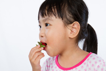 Asian Little Chinese Girl Eating Strawberry