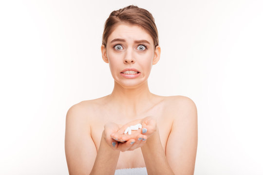 Funny woman holding pills