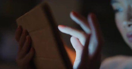 Beautiful asian woman using digital tablet technology at home late night - Powered by Adobe