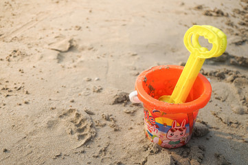 Fototapeta na wymiar Plastic toy bucket on the sand beach