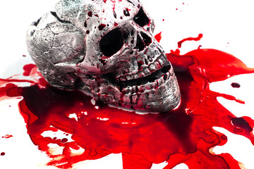 skull Conceptual image with blood on it resting on tiles on the floor