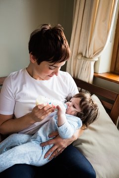 Cute Mother Bottle Feeding Her Baby