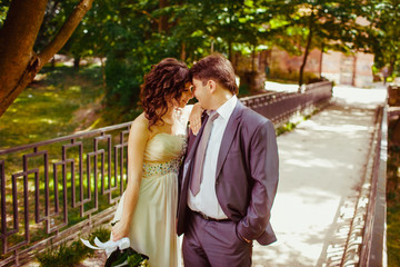 Happy newlywed romantic couple walking in the park