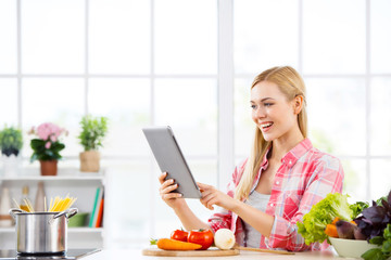 Young woman cooking in kitchen