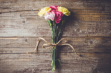 Carnation flowers on wooden table