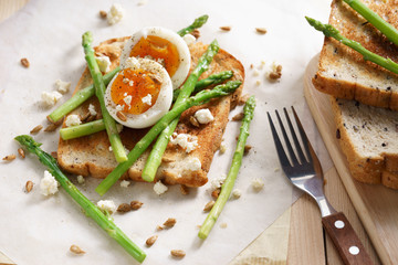 breakfast toast top with asparagus and soft boiled egg