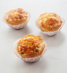 Savory cheese and bacon muffins on the white wooden table
