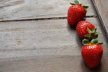 Red ripe strawberries on wooden backgrounds, close-up