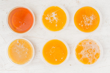 Cups with honey on a wooden table