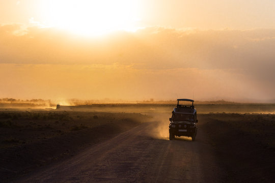 Fototapeta Sunset in african savannah, silhouettes of safari car and animals, Africa, Kenya, Amboseli national park  