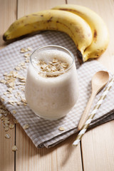 Banana smoothie on wooden background