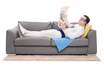 Relaxed superhero reading a newspaper