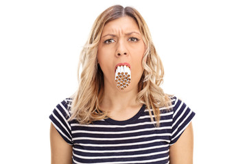 Woman with a bunch of cigarettes in her mouth