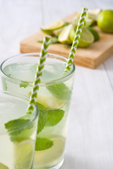 Summer drink. Fresh mojito with lime and mint. Blue background
