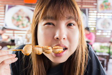 asia girl eating meat balls