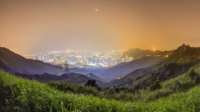 Cityscape of Hong Kong as viewed atop Kowloon Peak night timelapse with Hong kong and Kowloon below