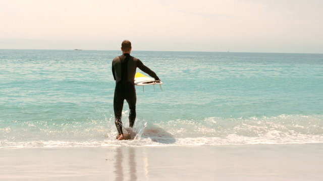 Man with surfboard running