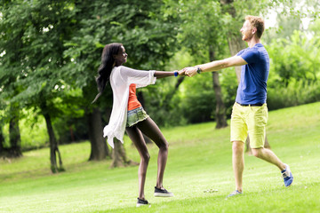 Beautiful couple dancing outdoors in a park