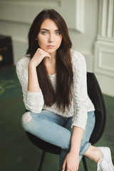 Portrait of a young lady in photostudio interior