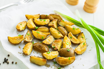 Potato wedges on parchment paper, vegetarian healthy food
