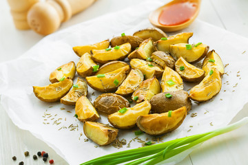 Potato wedges on parchment paper, vegetarian healthy food