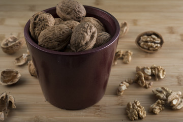 pile of walnuts in the foreground represent a healthy diet