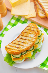 Plate with delicious sandwich on table, top view