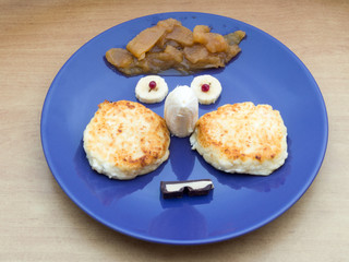 Plate with breakfast. Cheesecakes, banana, chocolate, apple jam.