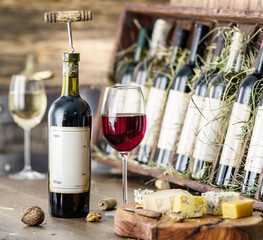 Glasses of wine and cheese plate. © volff