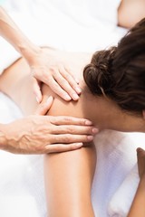 Fototapeta na wymiar Woman receiving a back massage from masseur