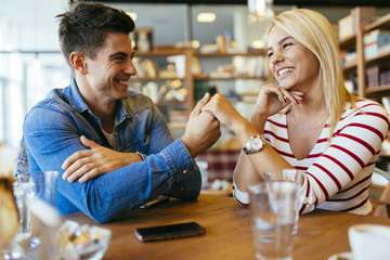 Beautiful couple in love flirting in cafe