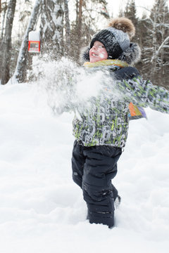 boy playing in the snow
