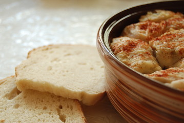 Sarma in ceramic dish with bread slices