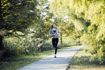 Fototapeta premium Fit beautiful woman jogging in park