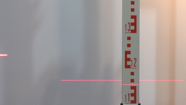 Laser level red light beam line and surveying staff or grade rod